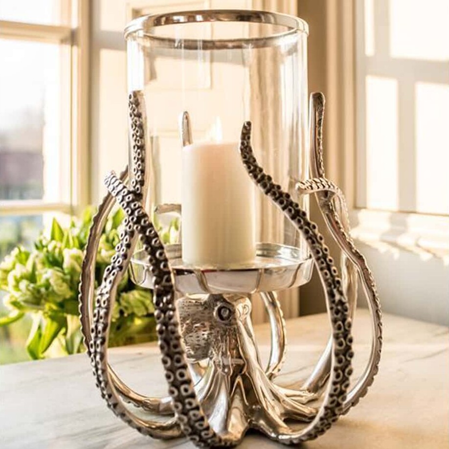 A silver octopus candle holder with intricate tentacles supporting a glass hurricane lantern, a statement piece from Empress Homewares.
