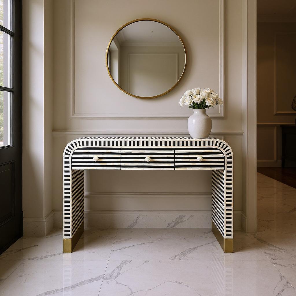 Striped bone inlay waterfall console table centred in a luxury entry hallway with gold round mirror and white roses, Empress Homewares Adelaide