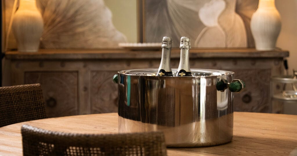 Champagne bottles in a metallic bucket on a table in dining room