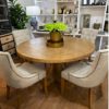 Elegant-round-dining-table-with-parquetry-top-and-natural-stain-finished-hardwood-150cm-in-a-display-room.